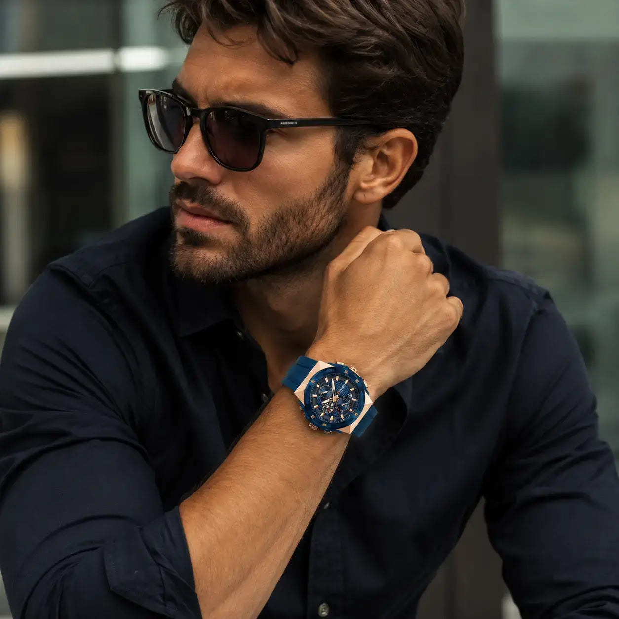 Man wearing Vortex™ Men’s Watch with blue strap and rose gold details
