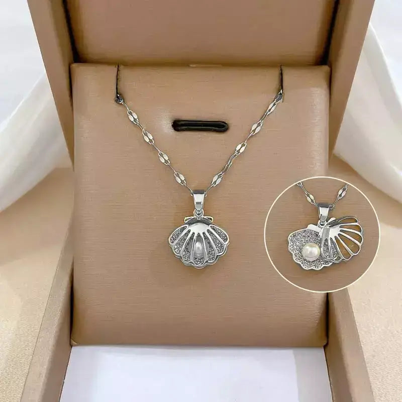 seashell pearl necklace, women’s seashell and pearl necklace, zirconia seashell necklace, elegant seashell necklace, modern pearl necklace, sophisticated women’s necklace, gift necklace for her, elegant beach style seashell necklace, women’s pearl jewellery, delicate seashell pendant necklace, luxury women’s necklace, pearl zirconia necklace gift, stainless steel women’s necklace, birthday gift necklace for women, necklace symbol of protection and love