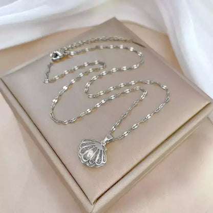 seashell pearl necklace, women’s seashell and pearl necklace, zirconia seashell necklace, elegant seashell necklace, modern pearl necklace, sophisticated women’s necklace, gift necklace for her, elegant beach style seashell necklace, women’s pearl jewellery, delicate seashell pendant necklace, luxury women’s necklace, pearl zirconia necklace gift, stainless steel women’s necklace, birthday gift necklace for women, necklace symbol of protection and love