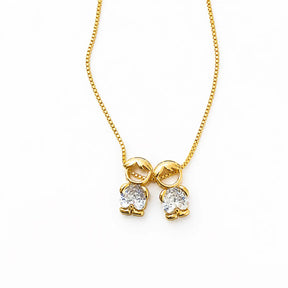 Gold-tone necklace with two boy figure pendants and white stones