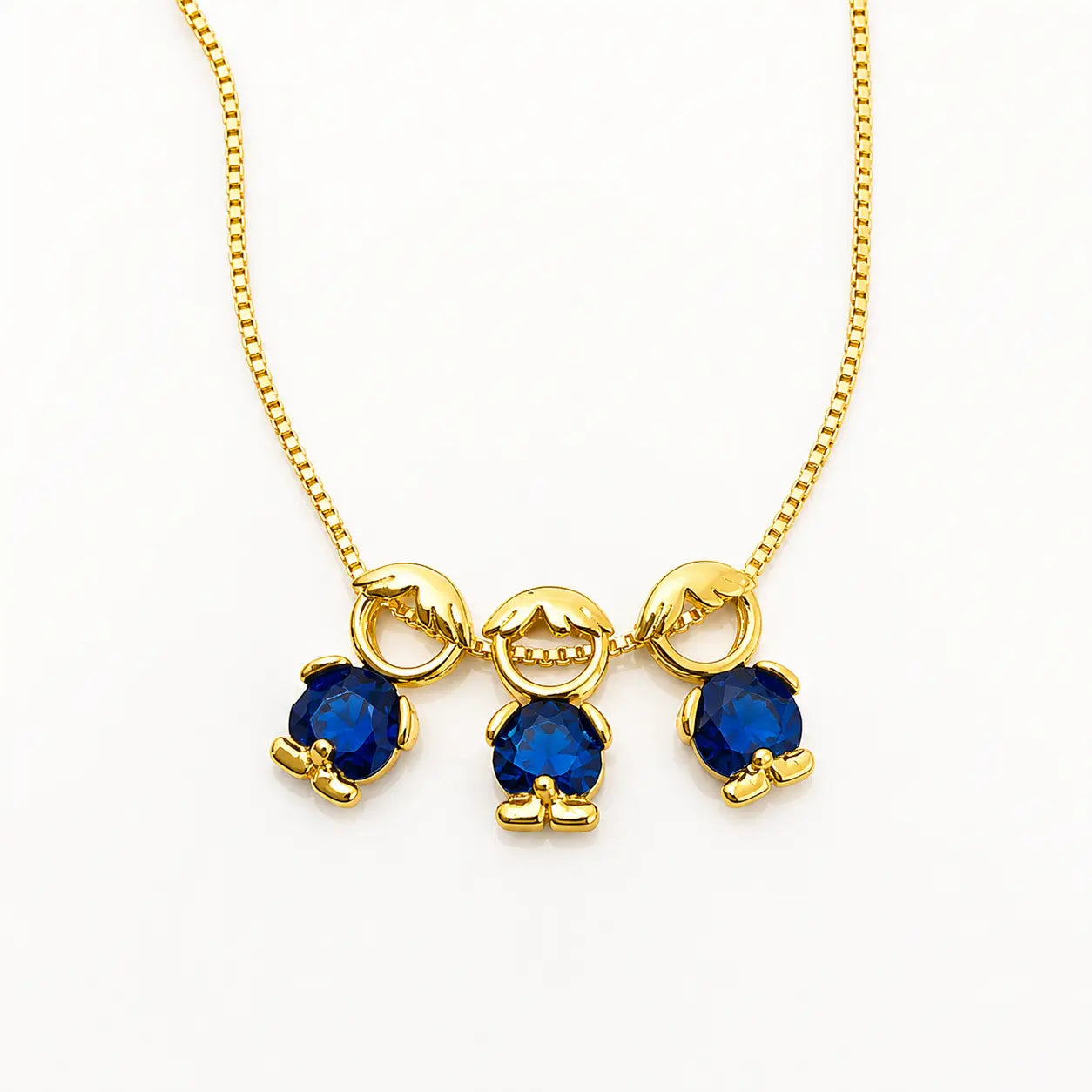 Gold-tone necklace with three boy figure pendants and blue stones