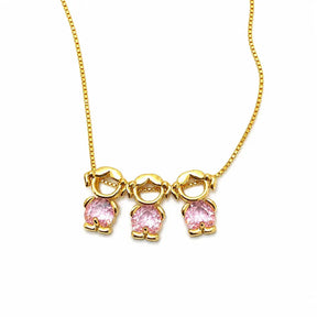 Gold-tone necklace with three girl figure pendants and pink stones