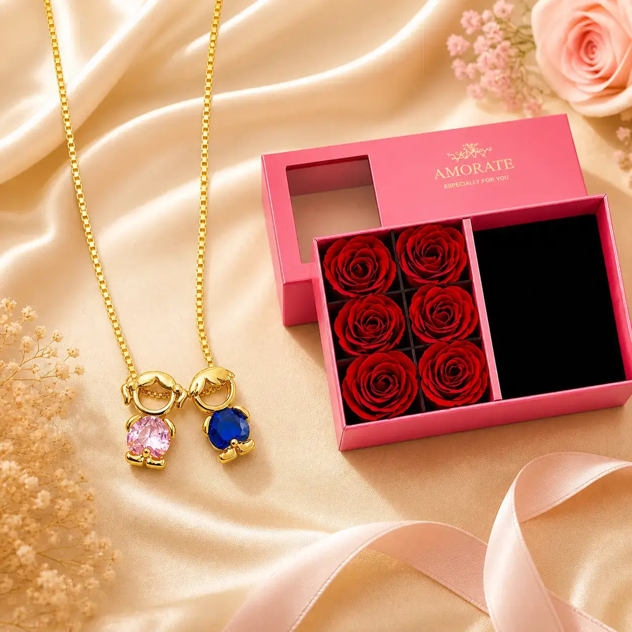 Mother & Child Love Necklace with pink and blue stones next to the luxury gift box with red roses