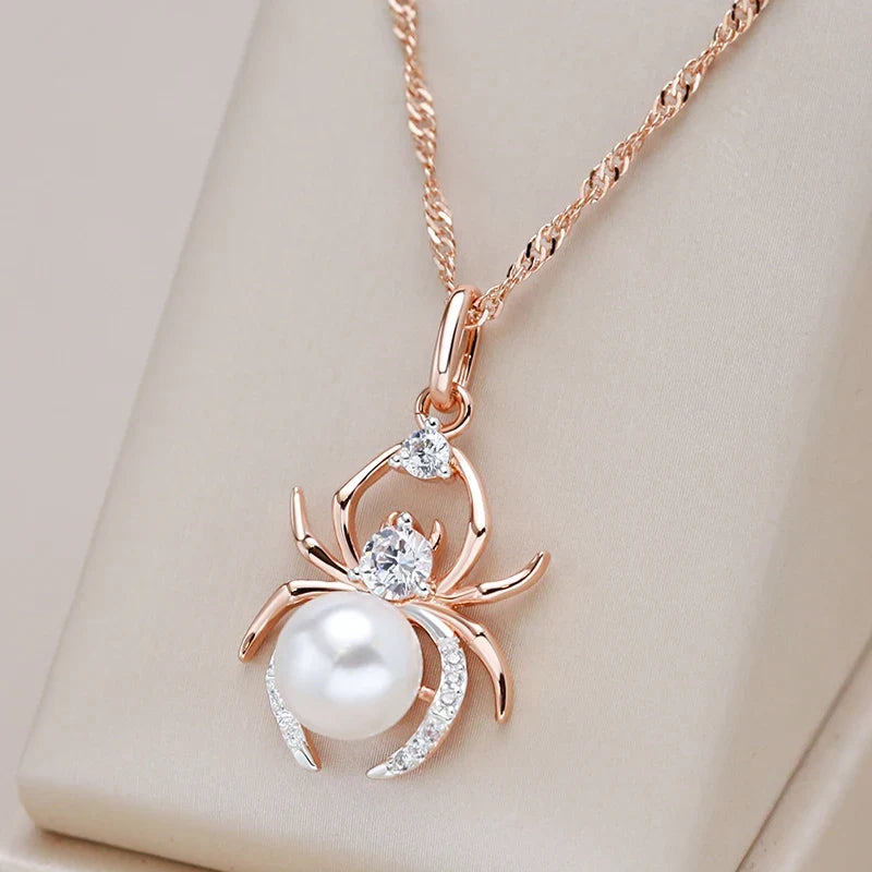 Pearl Weaver Necklace with a rose gold-colour spider pendant and pearl-style centrepiece on a soft beige display